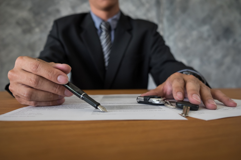 Business person in a suit holding a pen