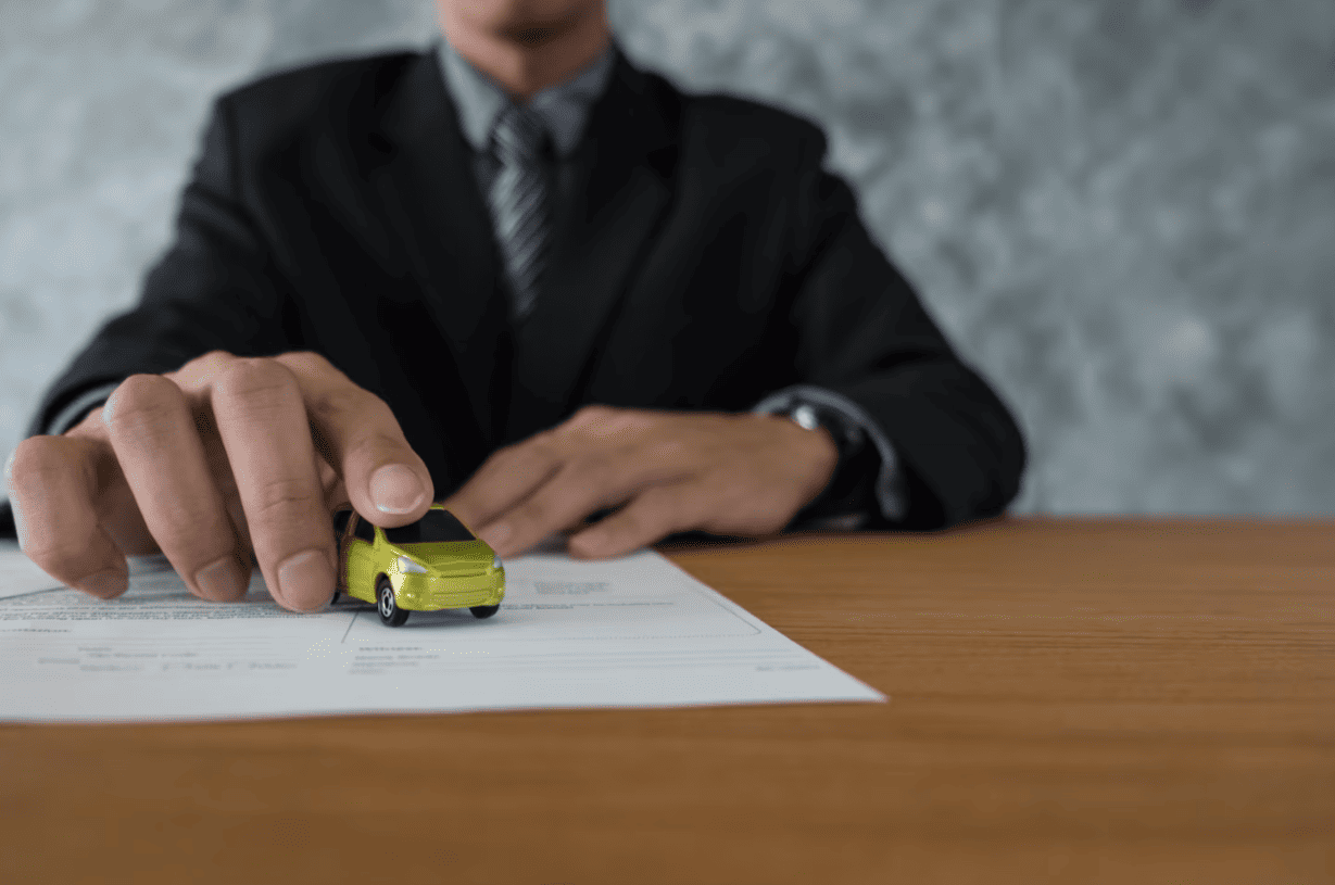 car-insurance-agreement-model-car.jpg Businessman signing car insurance with a toy car model