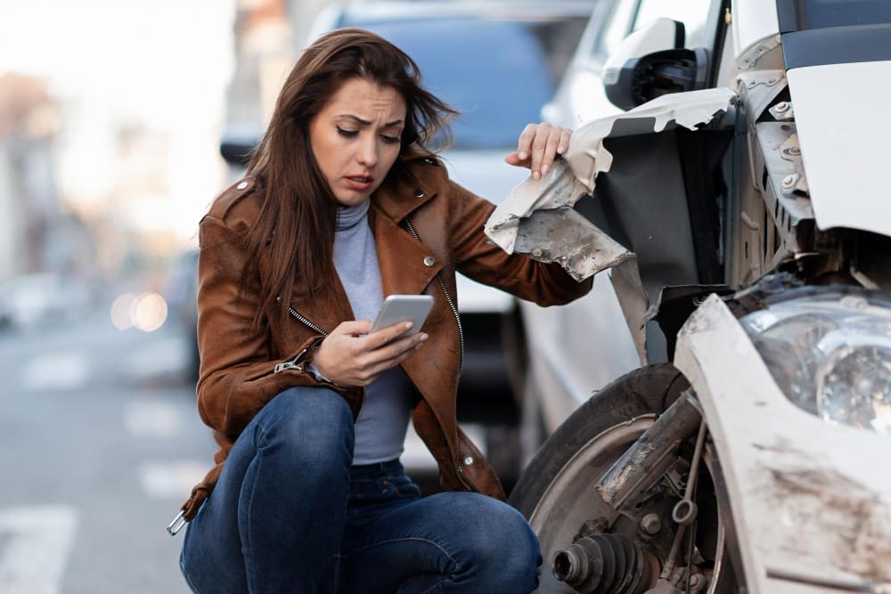 dealing-with-car-accident-damage Woman dealing with car accident