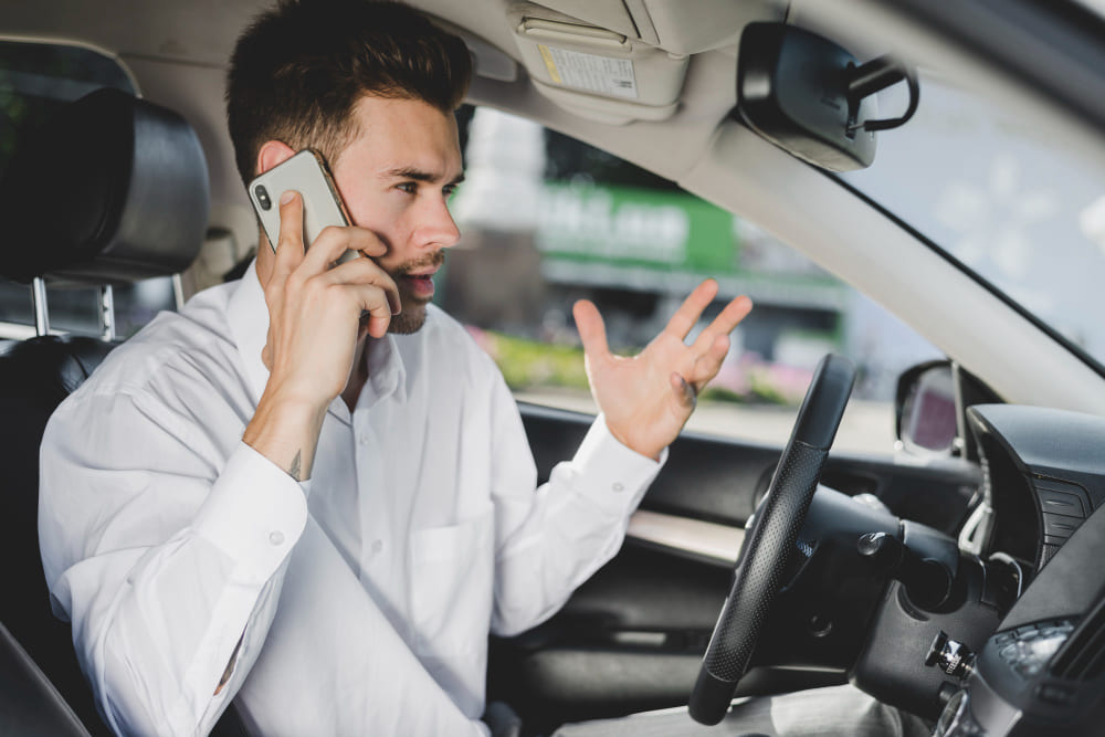Man sitting in a car, talking on the phone