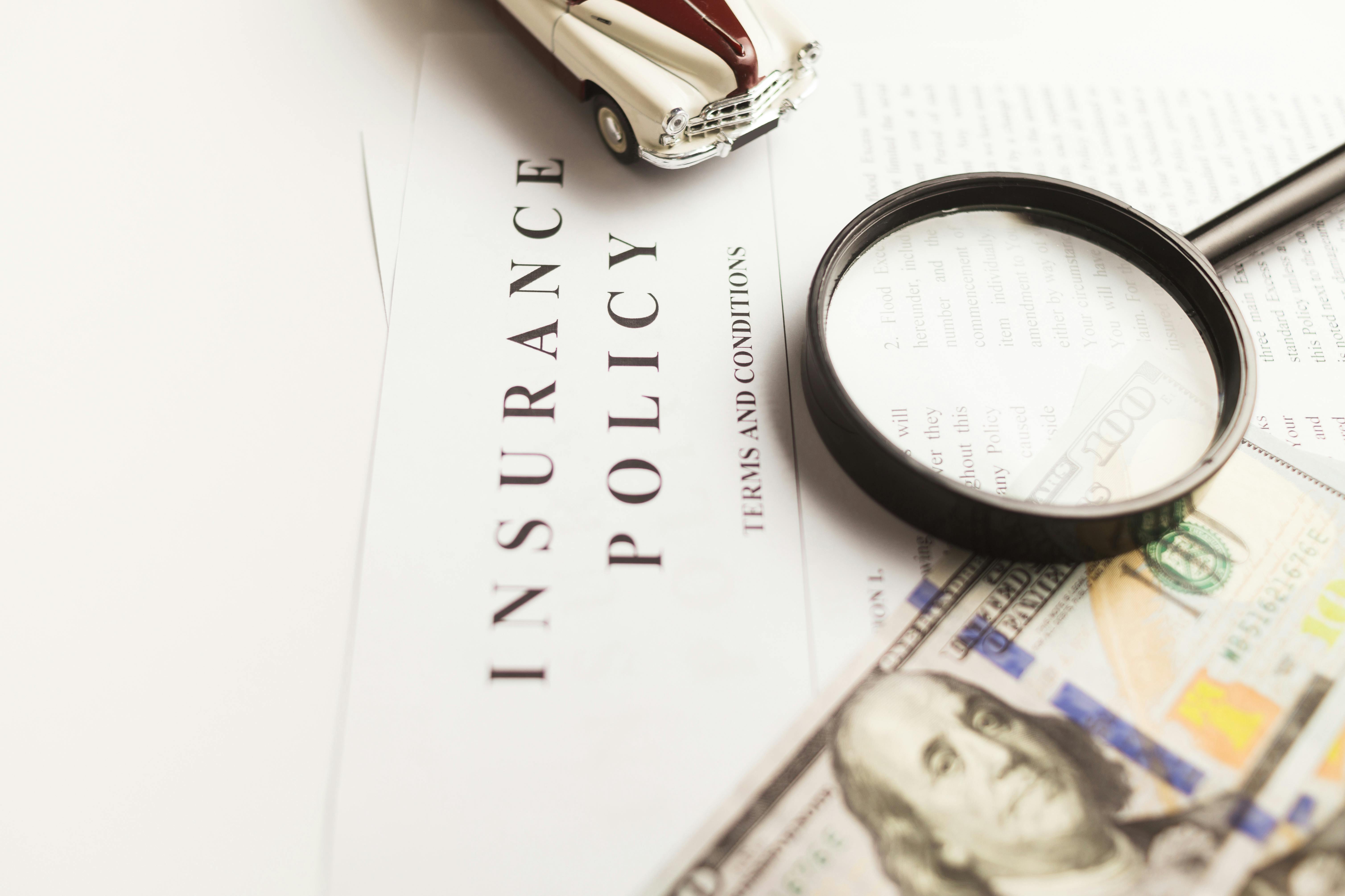 Auto insurance policy document with a magnifying glass